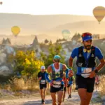 Coureurs traversant les formations rocheuses d'AlUla au lever du soleil lors d'un duathlon